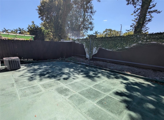 view of patio / terrace featuring a fenced backyard and central air condition unit