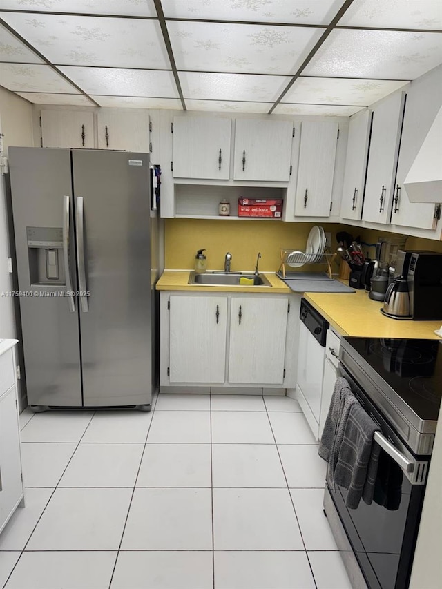 kitchen with light tile patterned floors, electric range, white dishwasher, light countertops, and stainless steel refrigerator with ice dispenser