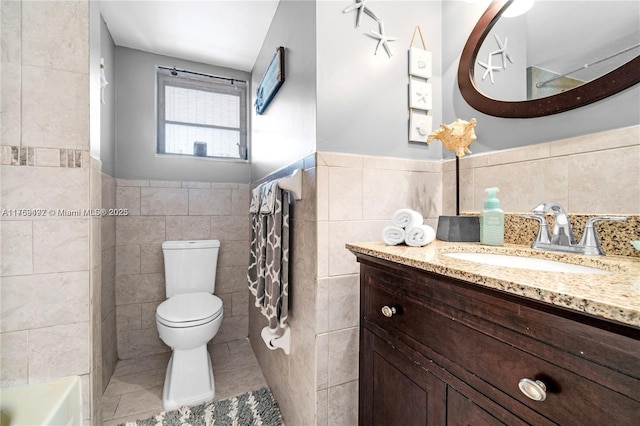 full bathroom with toilet, vanity, tile patterned flooring, and tile walls