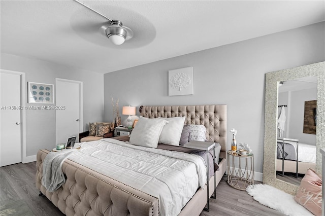 bedroom with baseboards, a ceiling fan, and wood finished floors