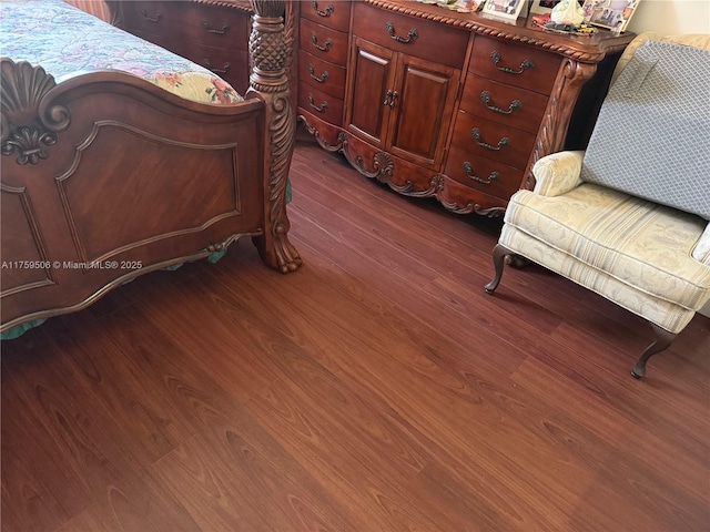 bedroom with dark wood finished floors