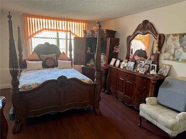 bedroom featuring dark wood-style floors and a textured ceiling