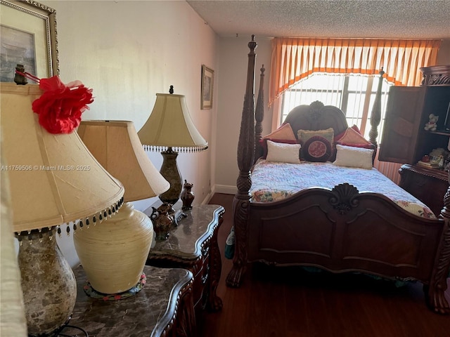 bedroom featuring a textured ceiling and wood finished floors