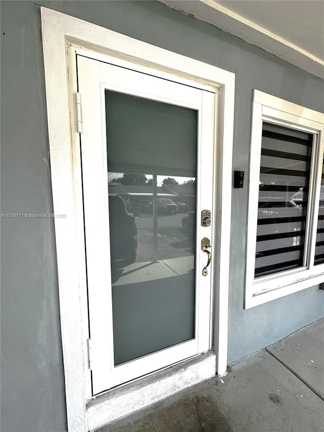 property entrance with stucco siding