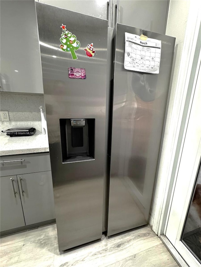 interior space featuring stainless steel fridge with ice dispenser