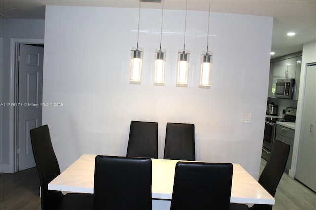 dining space featuring recessed lighting and wood finished floors