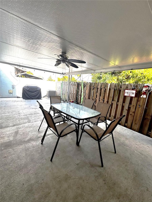 view of patio with outdoor dining space and a ceiling fan