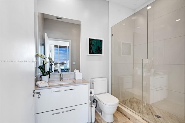 full bath with vanity, a shower stall, and toilet