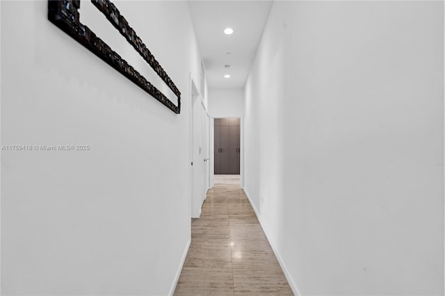 corridor featuring recessed lighting and baseboards