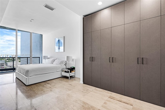 bedroom featuring access to outside, floor to ceiling windows, and visible vents