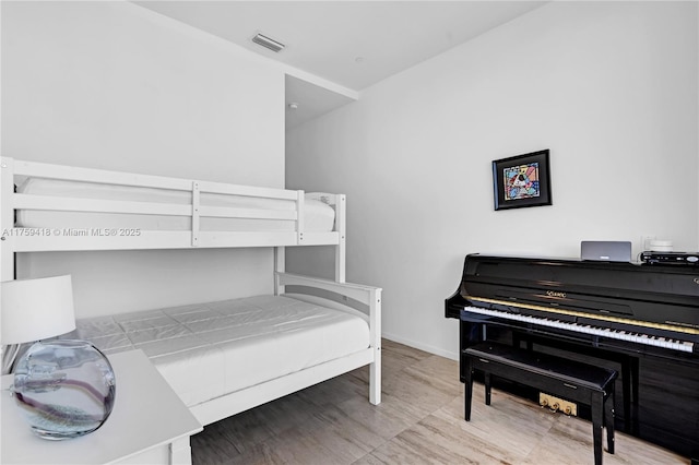 bedroom with visible vents and baseboards