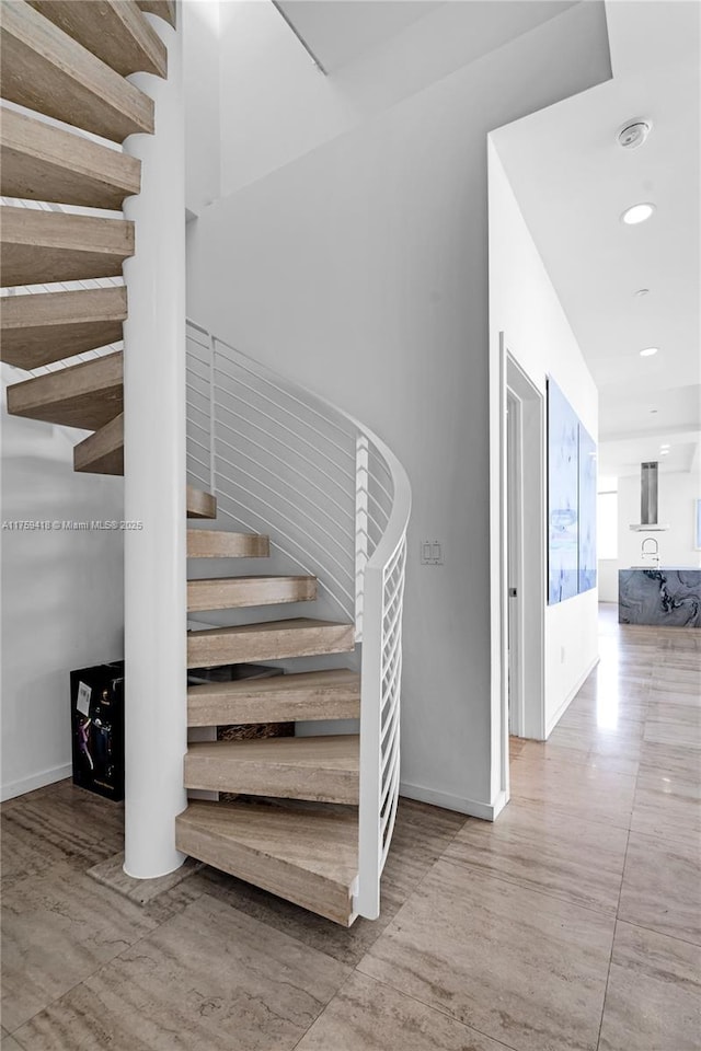 stairs featuring recessed lighting and baseboards