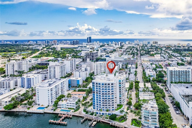 drone / aerial view with a city view and a water view