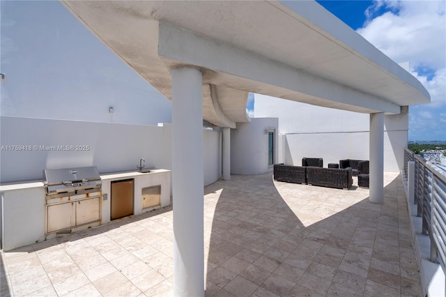 view of patio / terrace with a grill, a sink, and area for grilling