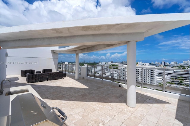 view of patio / terrace with a view of city and a sink