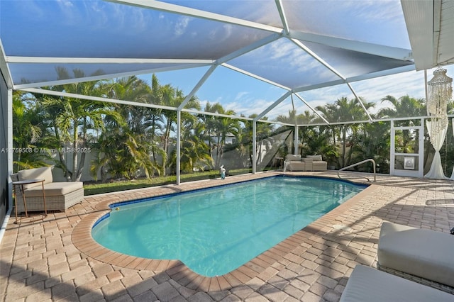 pool with an outdoor hangout area, a patio area, and a lanai