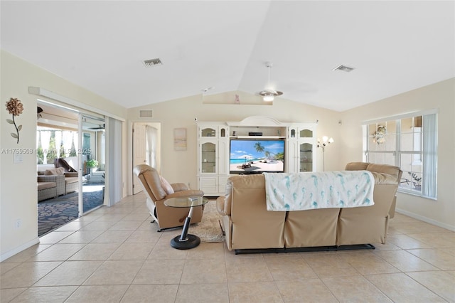 living area featuring vaulted ceiling, light tile patterned flooring, and visible vents