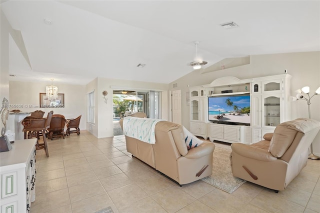 living area featuring lofted ceiling, light tile patterned floors, and visible vents