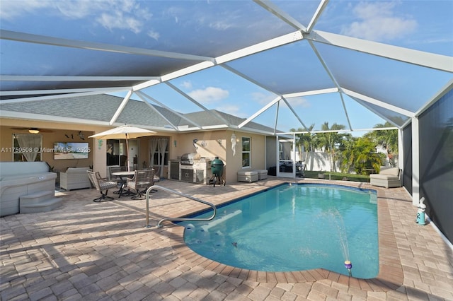 pool featuring glass enclosure, outdoor dining area, and a patio