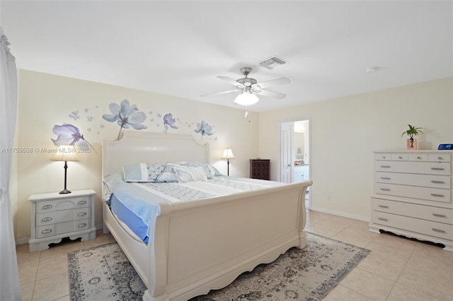 bedroom featuring ceiling fan, light tile patterned flooring, visible vents, baseboards, and ensuite bath