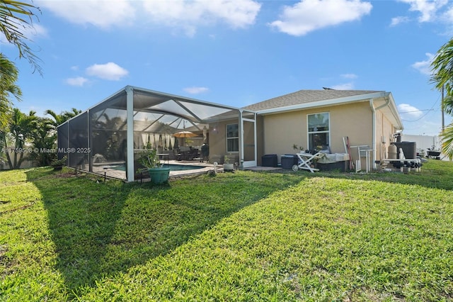 back of house featuring glass enclosure, a lawn, an outdoor pool, and stucco siding