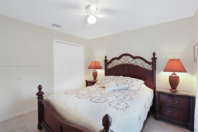 bedroom with light tile patterned floors, visible vents, baseboards, a ceiling fan, and a closet