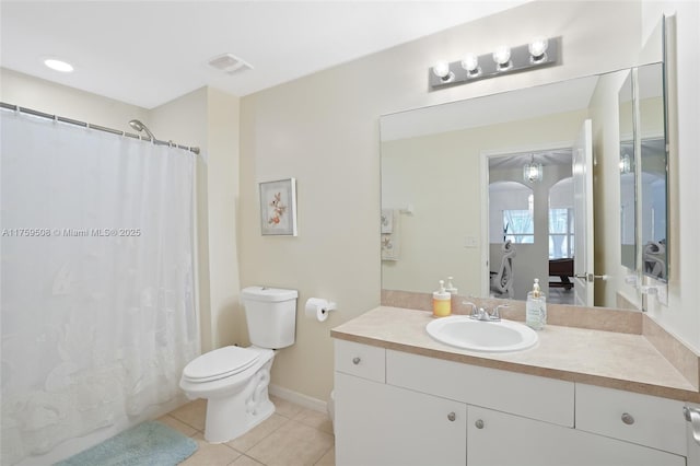 bathroom with visible vents, toilet, ensuite bathroom, vanity, and tile patterned flooring