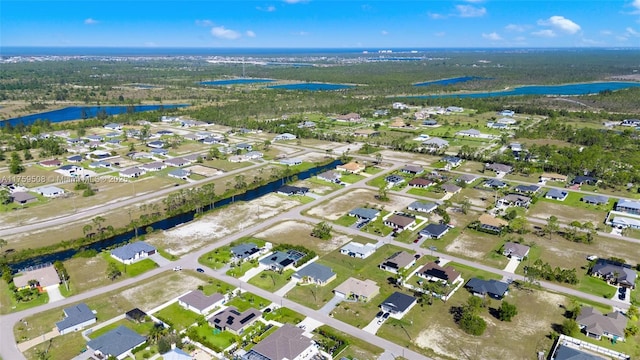 drone / aerial view featuring a water view and a residential view