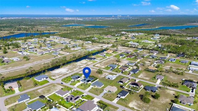 drone / aerial view with a water view and a residential view