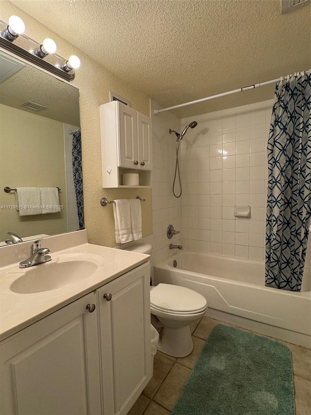 full bathroom featuring a textured ceiling, shower / bath combo with shower curtain, and tile patterned floors