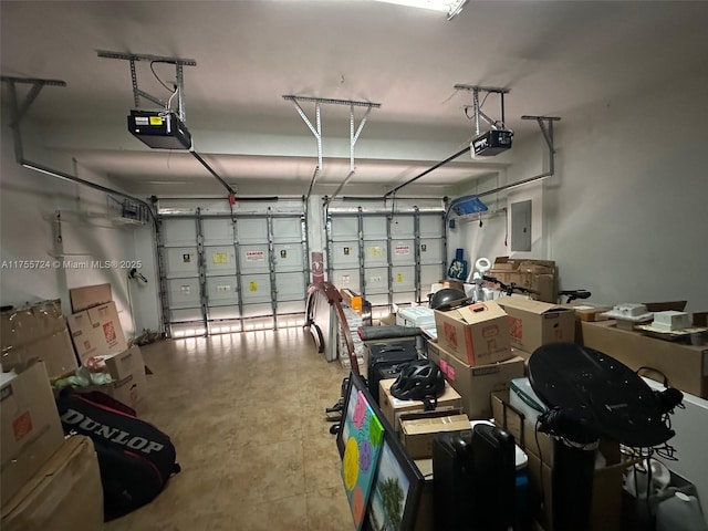 garage with electric panel and a garage door opener