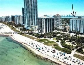 bird's eye view featuring a view of the beach, a view of city, and a water view