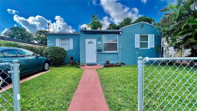 1770 NW 51st Ter, Miami, FL 33142 - view of front of house featuring a front yard, fence, and stucco siding
