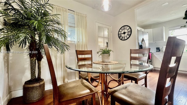 dining space with wood finished floors