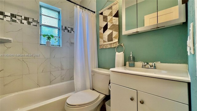 bathroom featuring toilet, shower / tub combo, and vanity