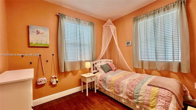 bedroom featuring baseboards and wood finished floors