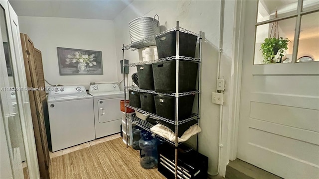 washroom featuring laundry area, light wood finished floors, and washer and dryer