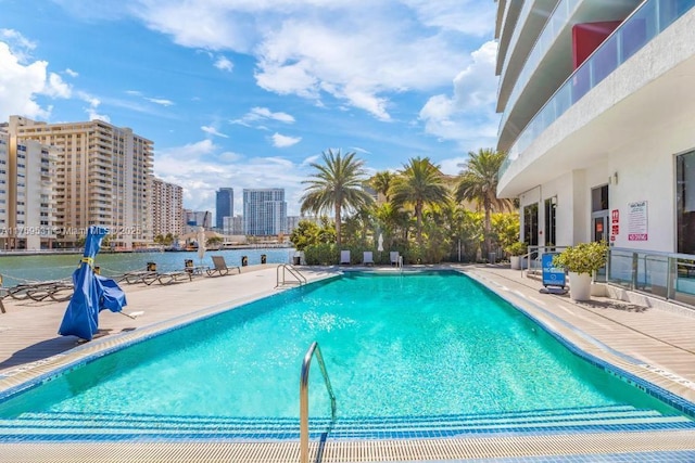 pool with a view of city and a patio area