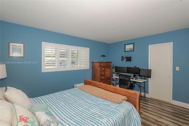 bedroom featuring baseboards and wood finished floors