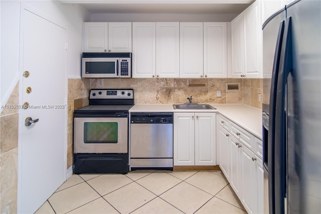 kitchen with appliances with stainless steel finishes, a sink, and white cabinets