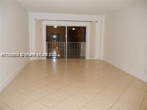 unfurnished room with baseboards