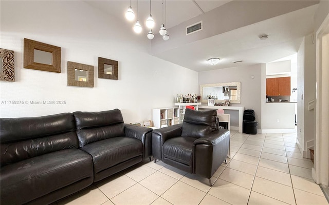 living room featuring visible vents, baseboards, and light tile patterned flooring