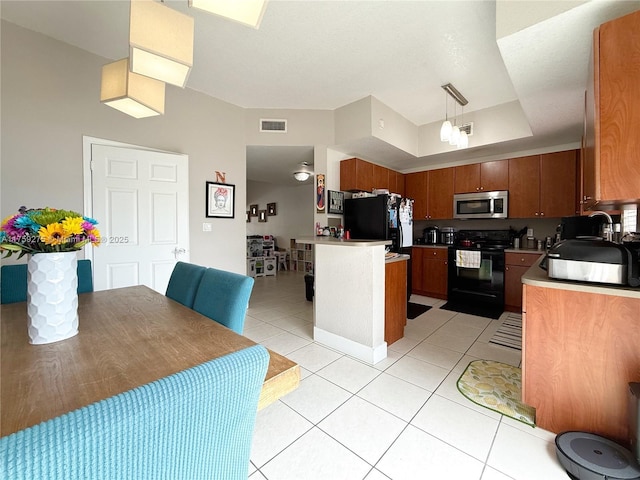 kitchen with light tile patterned floors, black appliances, visible vents, and brown cabinets