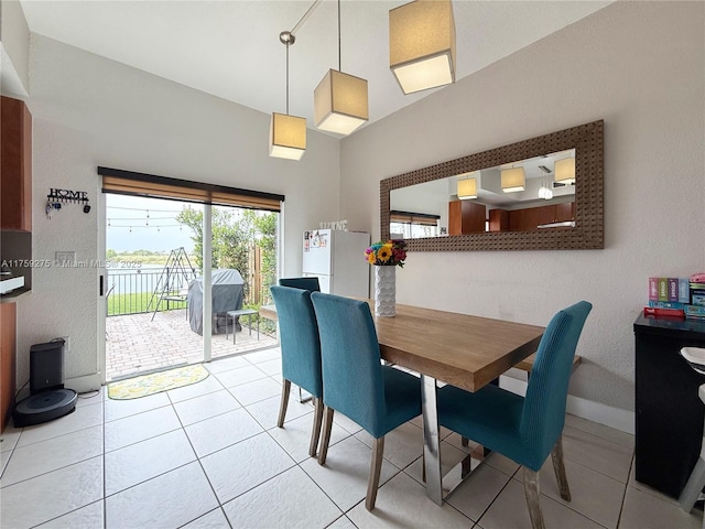 dining area featuring baseboards and light tile patterned flooring