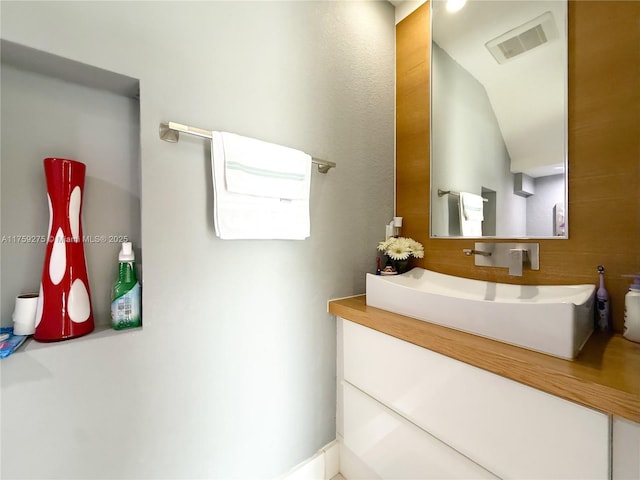 bathroom with visible vents and vanity