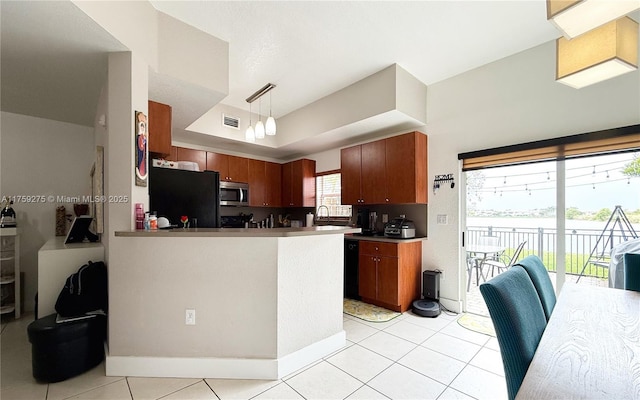 kitchen with visible vents, decorative light fixtures, a peninsula, black appliances, and a sink