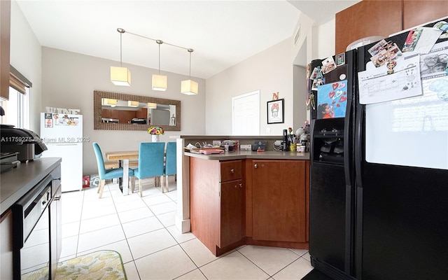 kitchen featuring light tile patterned floors, freestanding refrigerator, a peninsula, hanging light fixtures, and black refrigerator with ice dispenser