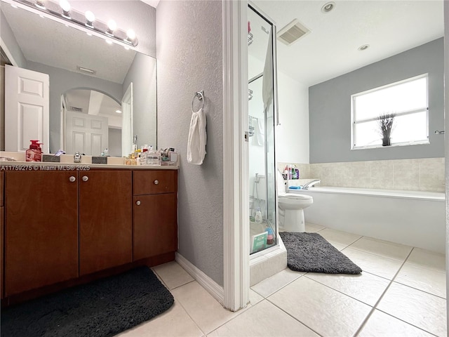 full bath with a stall shower, vanity, visible vents, and tile patterned floors