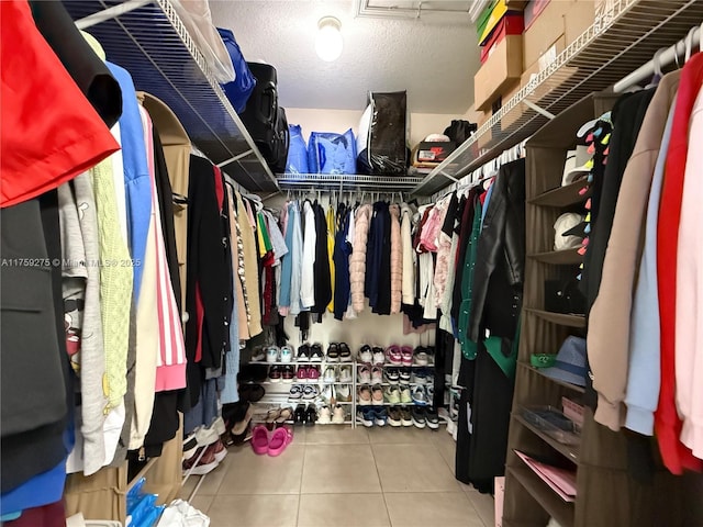 walk in closet with tile patterned floors