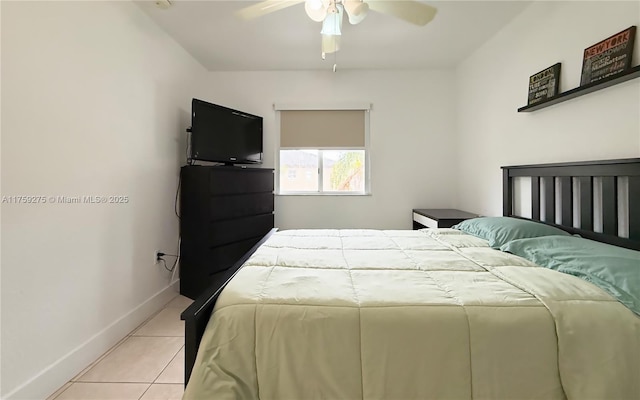 bedroom featuring ceiling fan, baseboards, and light tile patterned floors